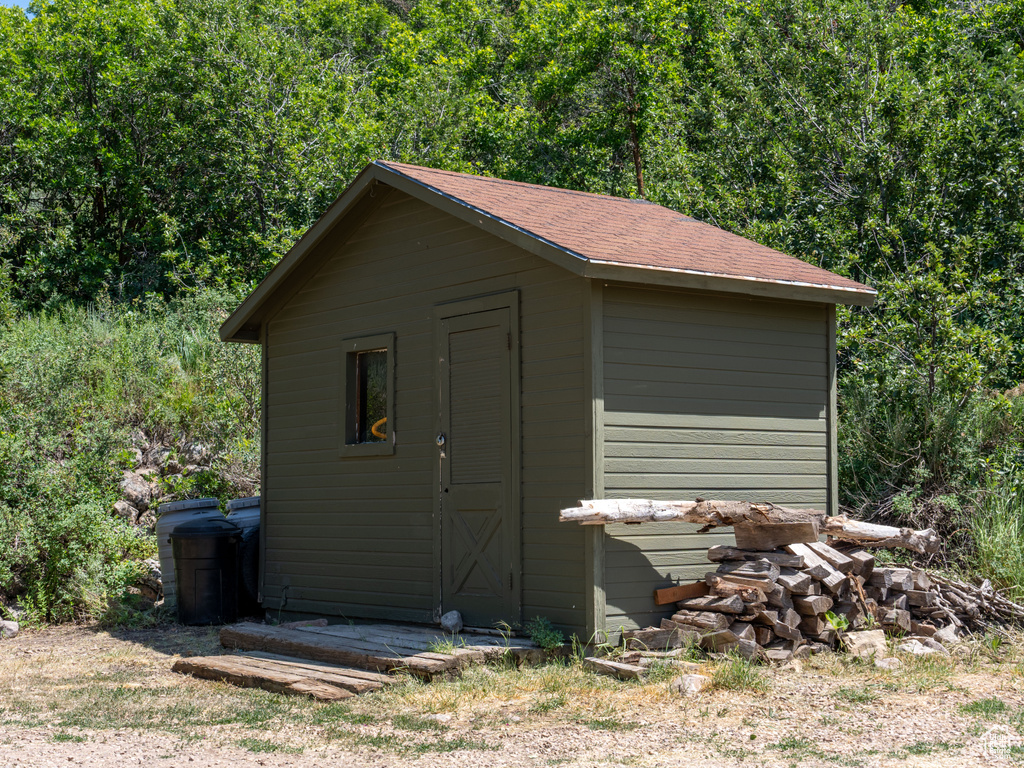 View of shed featuring a view of trees
