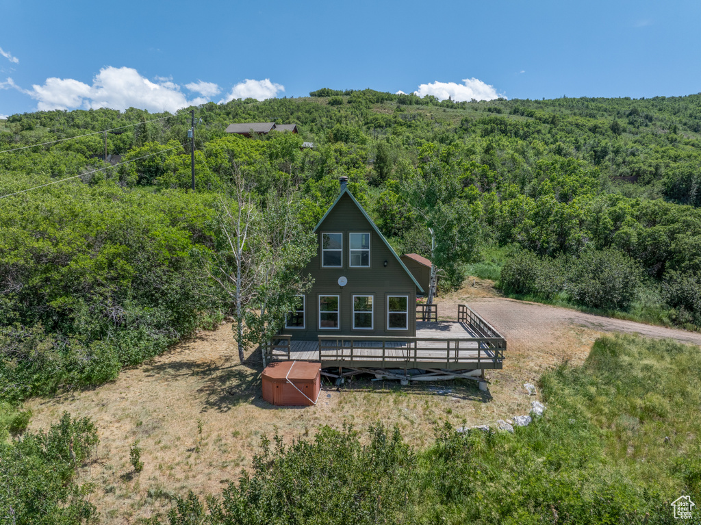 Rear view of house with a forest view