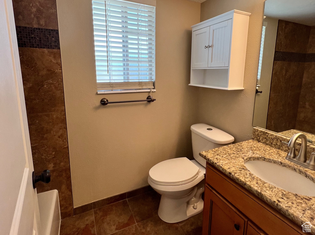 Full bathroom featuring vanity, a textured ceiling, and tub / shower combination