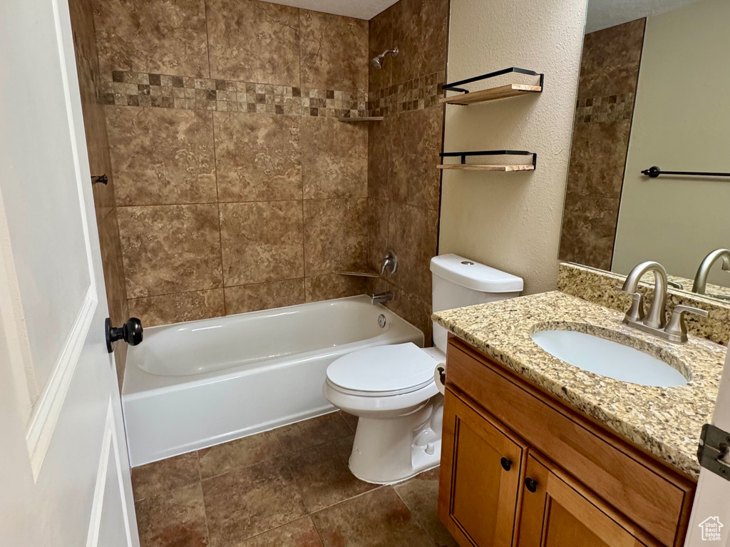 Full bathroom featuring shower / bath combination, vanity, and a textured ceiling