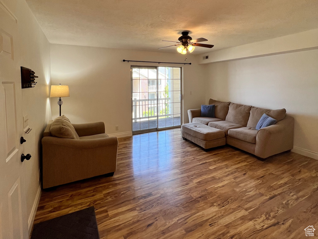Living area featuring wood finished floors and ceiling fan