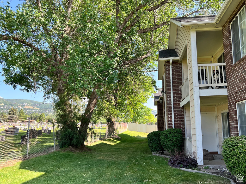 View of yard featuring a balcony