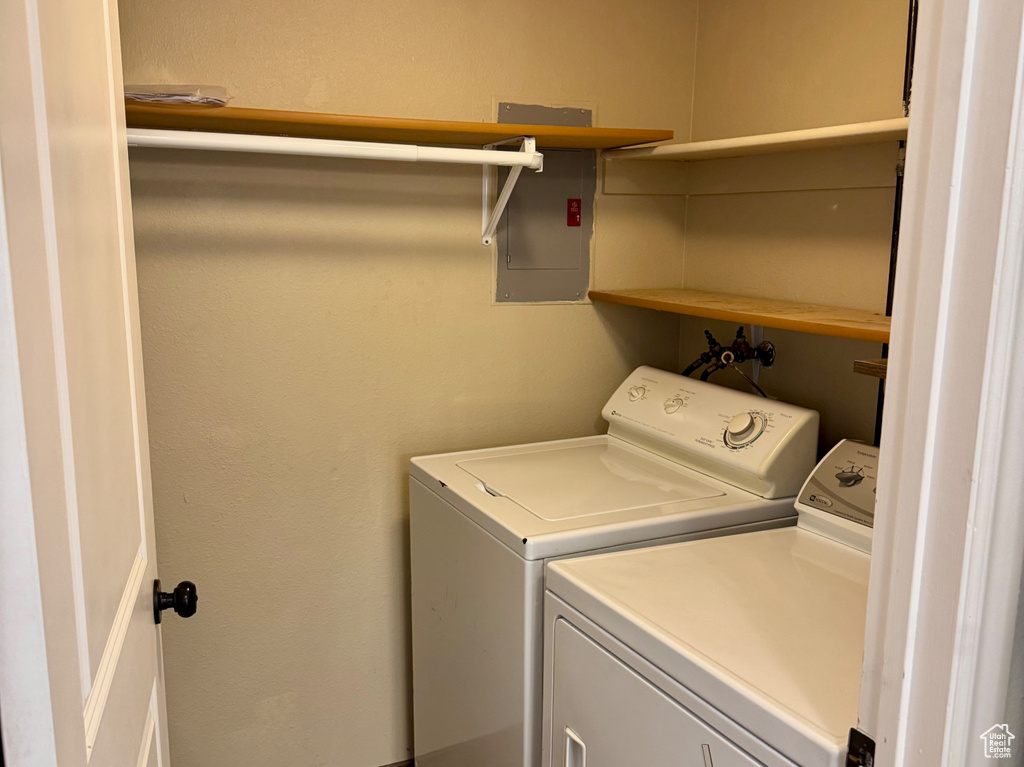 Laundry room featuring washing machine and clothes dryer and electric panel