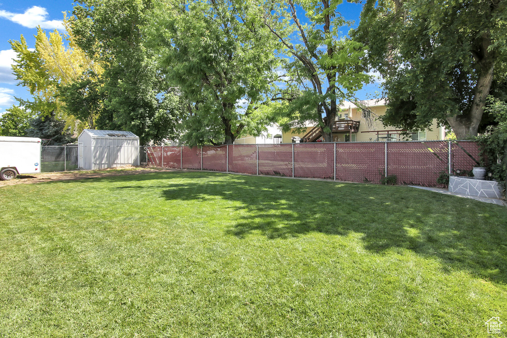 Fenced backyard with a storage shed