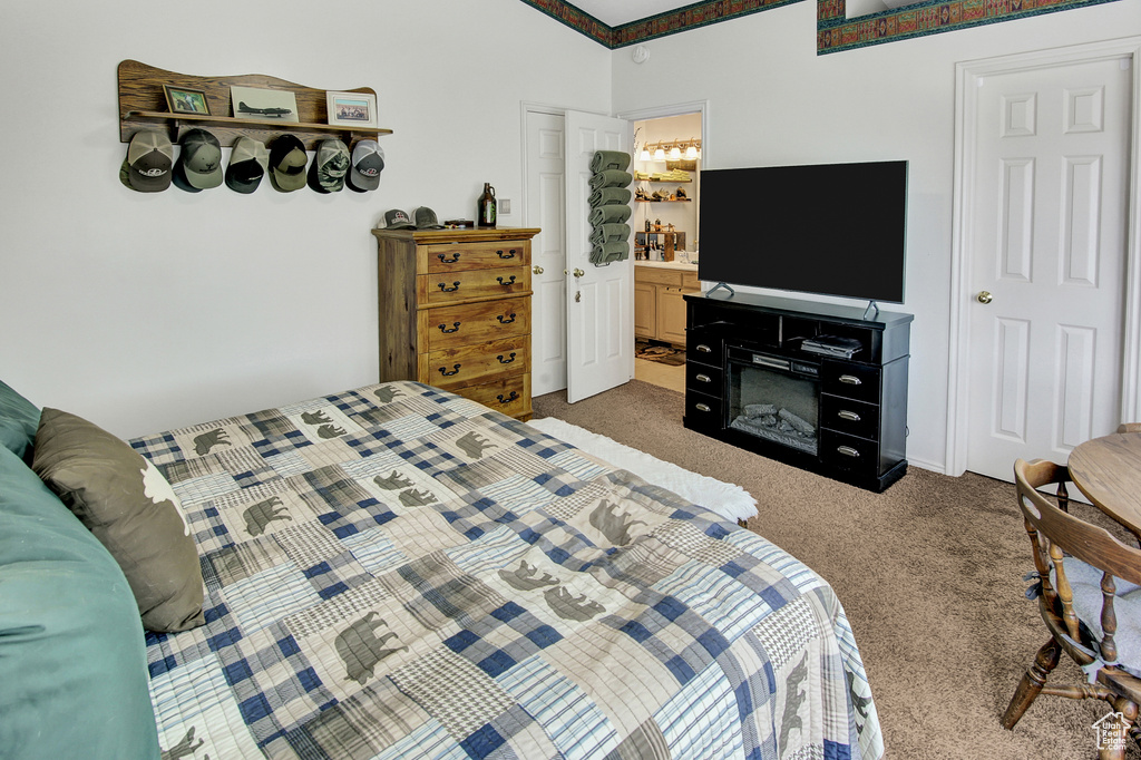 Bedroom featuring carpet floors and ensuite bath