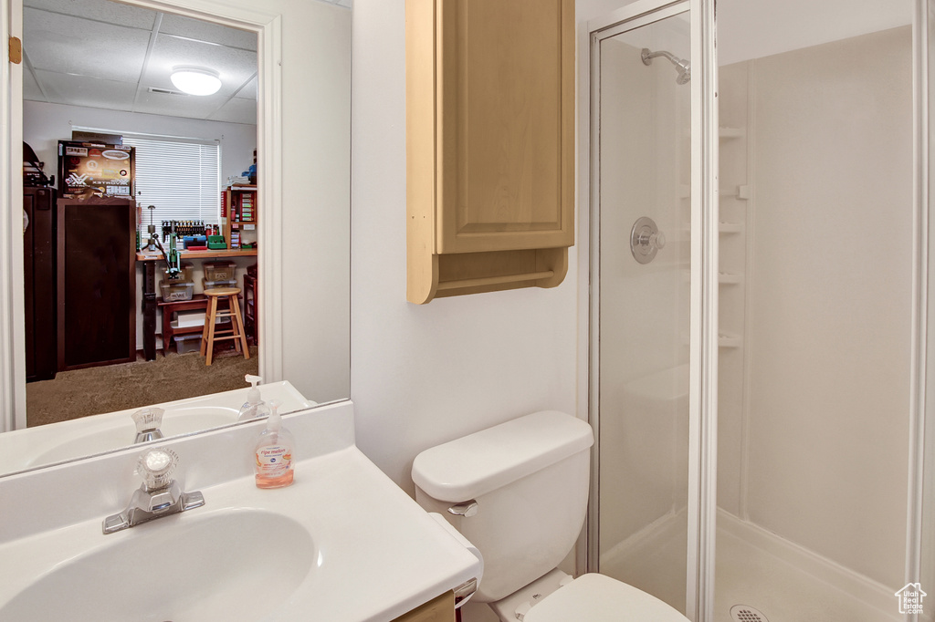 Bathroom featuring a shower stall and vanity