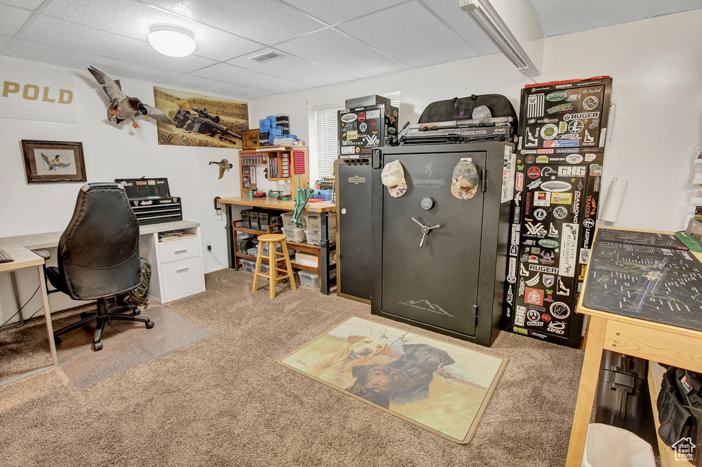 Office space with carpet and a paneled ceiling