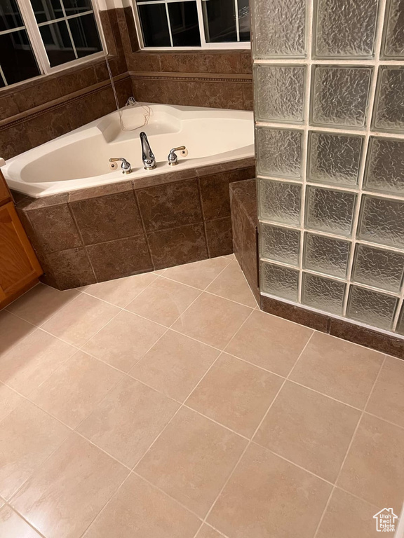 Bathroom with a bath and tile patterned floors