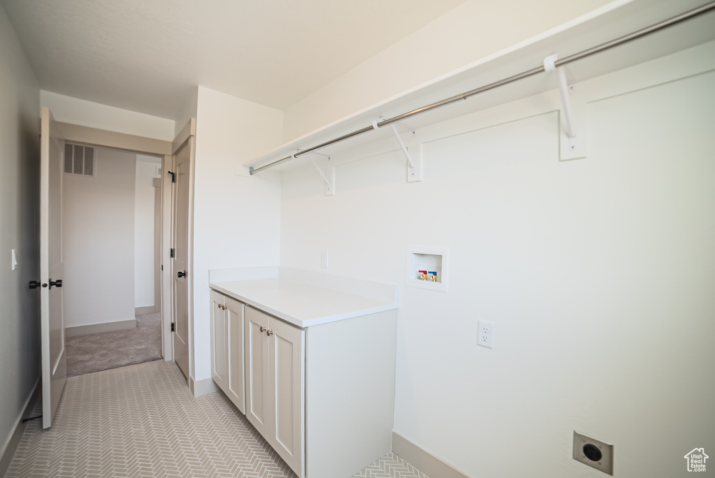 Laundry area featuring electric dryer hookup, washer hookup, and light colored carpet