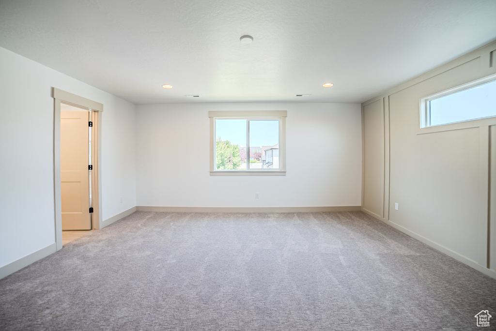 Spare room featuring light colored carpet and recessed lighting