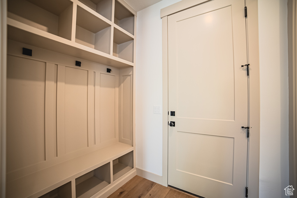 Mudroom with light wood-type flooring and baseboards
