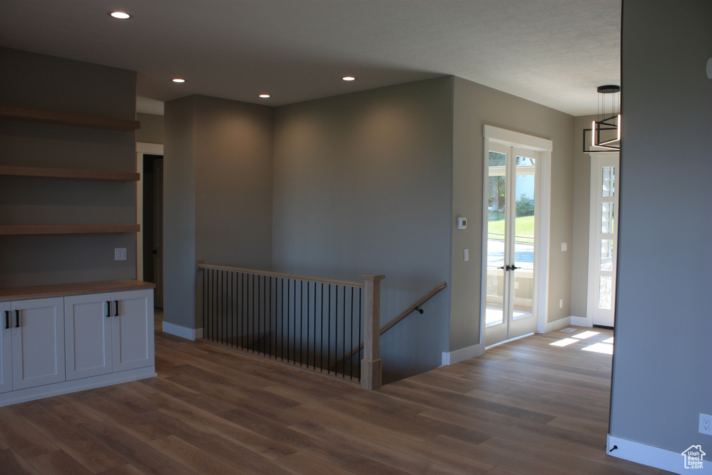 Corridor with an upstairs landing, dark wood-style flooring, and recessed lighting