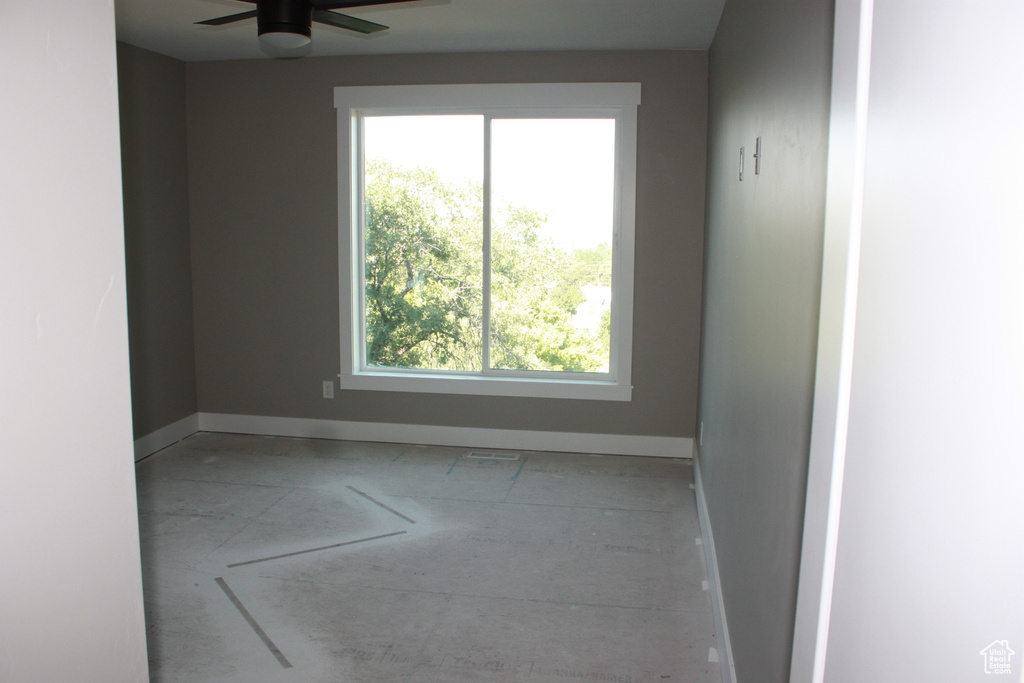 Spare room with baseboards and ceiling fan