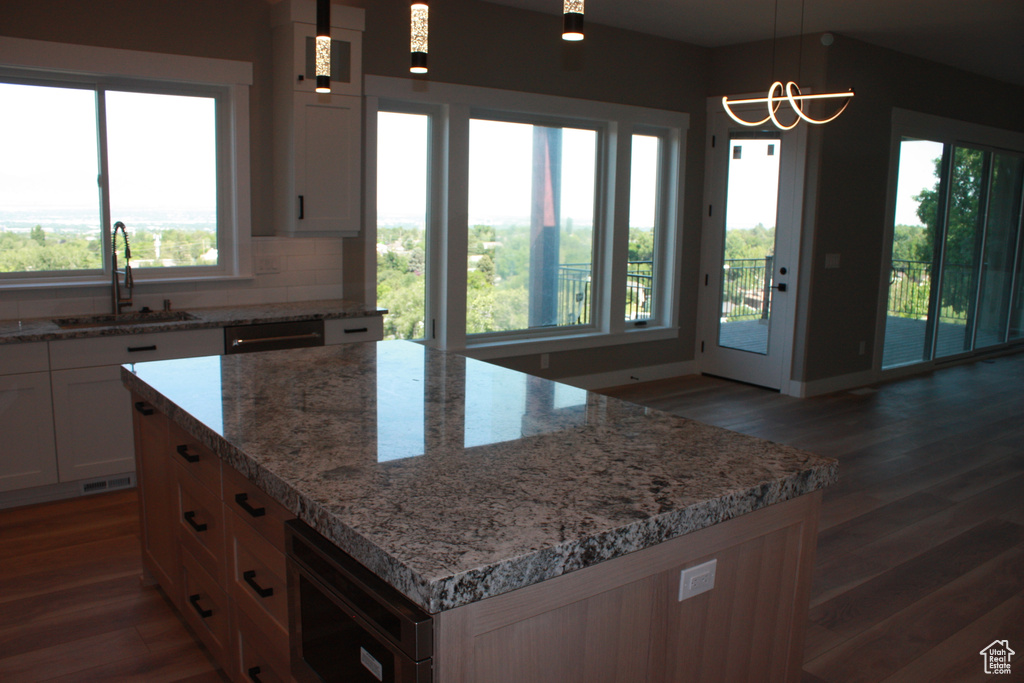 Kitchen with wood finished floors and plenty of natural light