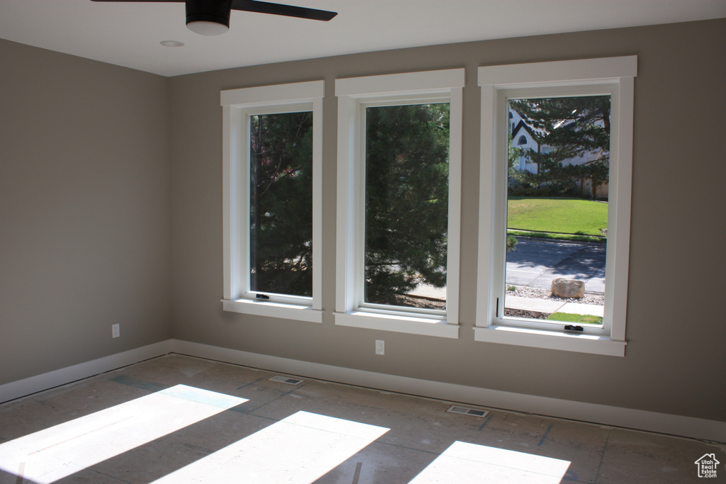 Spare room with a ceiling fan and baseboards