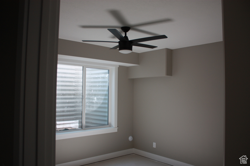Unfurnished room with plenty of natural light and ceiling fan
