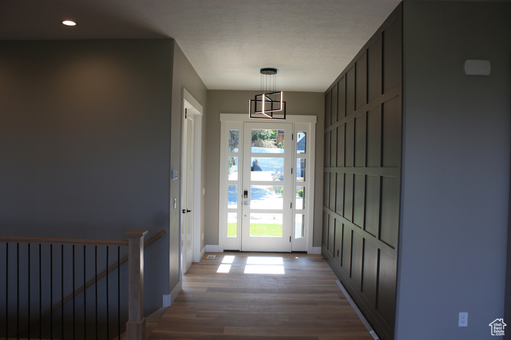 Entryway with wood finished floors and recessed lighting