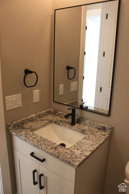 Bathroom featuring vanity and toilet