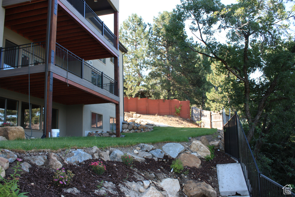 View of yard with a balcony