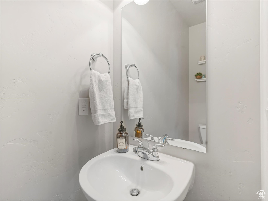 Half bathroom featuring a sink