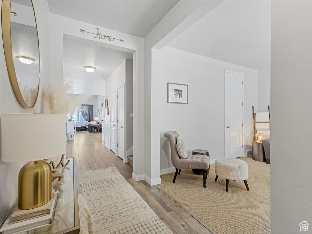 Corridor featuring wood finished floors