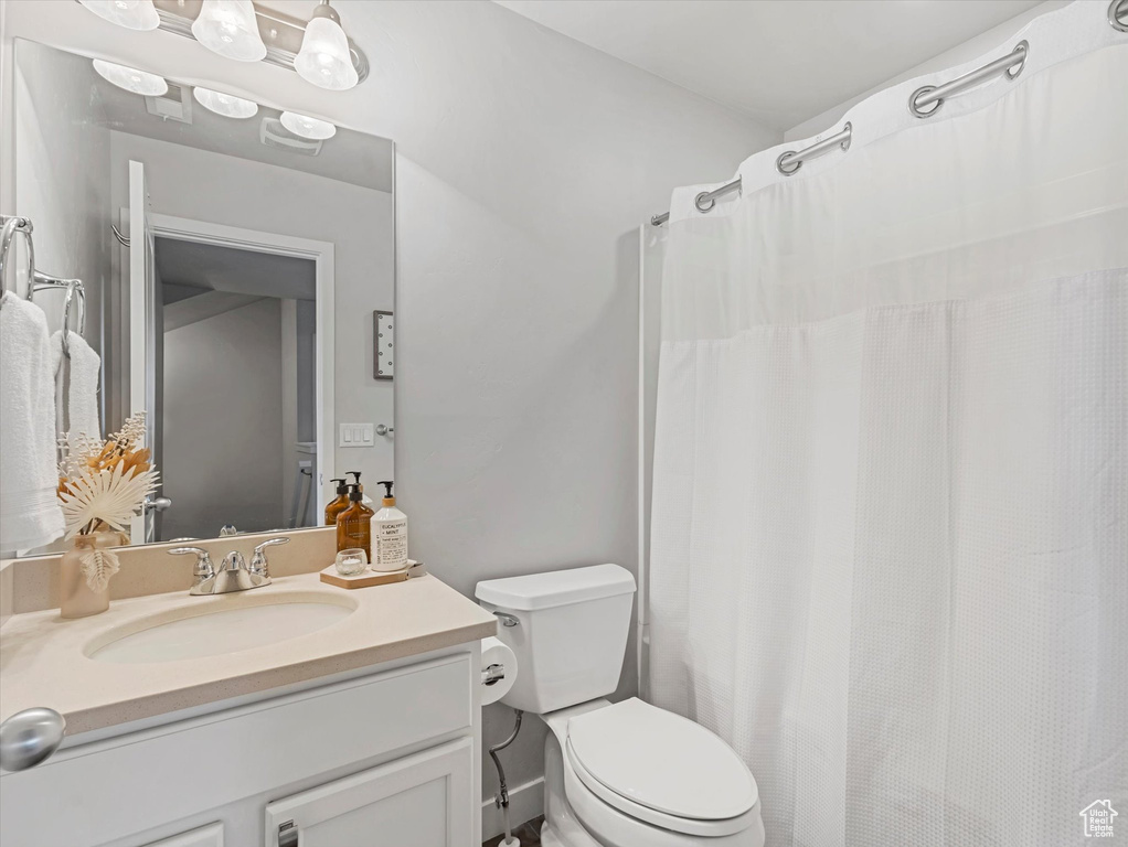 Full bathroom with vanity and toilet