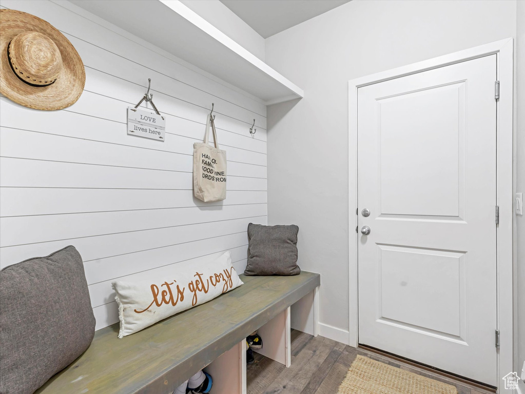 Mudroom with wood finished floors and baseboards
