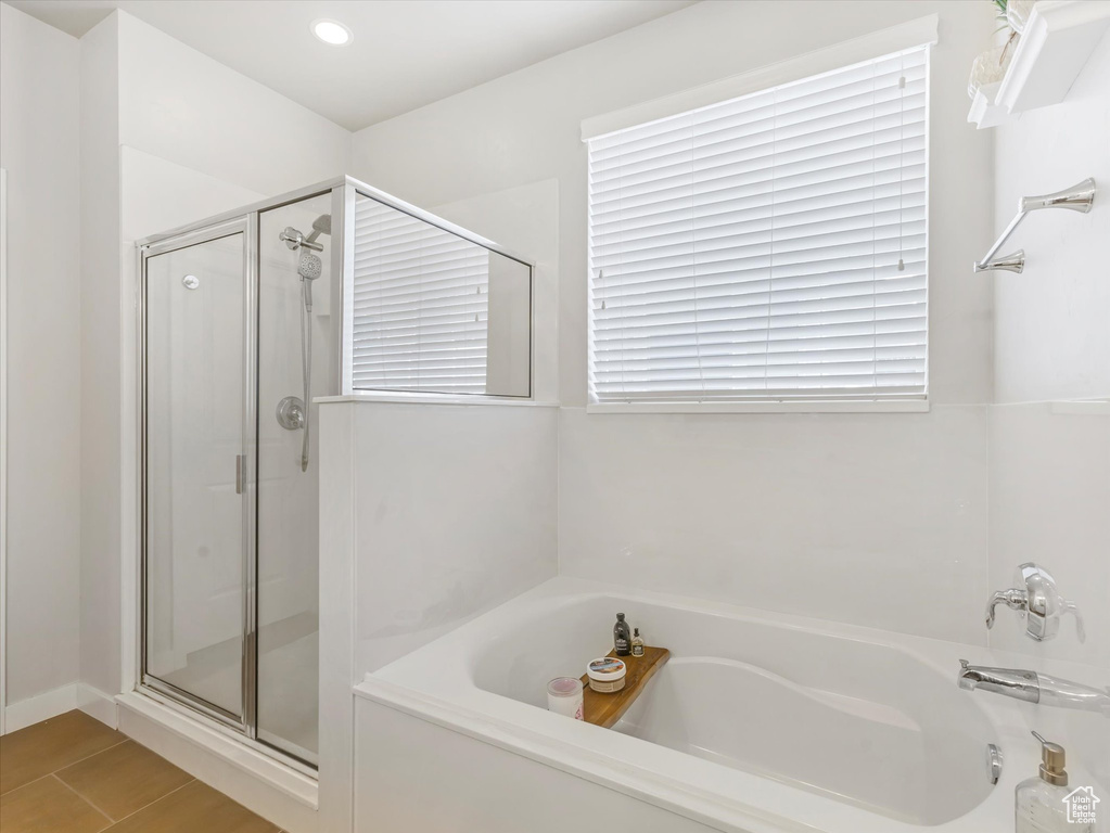 Bathroom with a bath, a stall shower, and recessed lighting