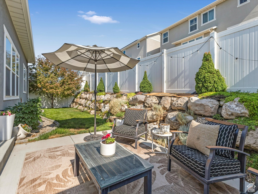 Fenced backyard with a patio and a gate