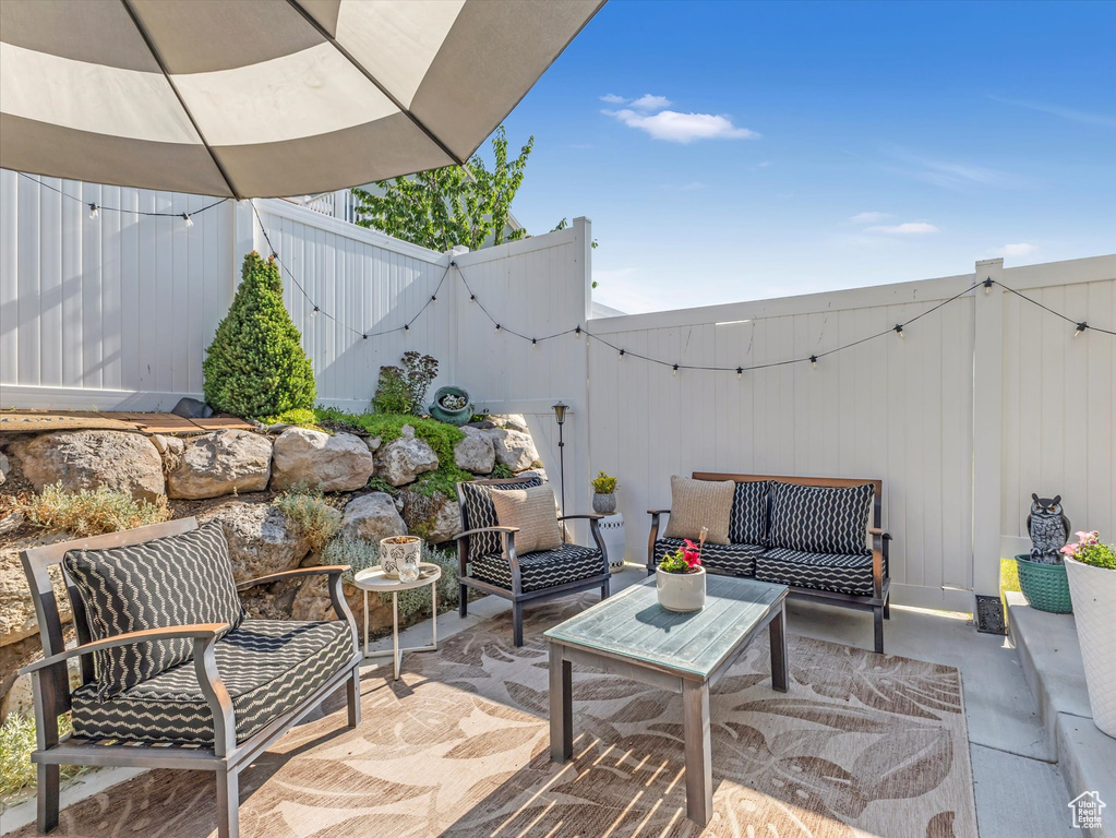 Fenced backyard featuring a patio area and an outdoor living space