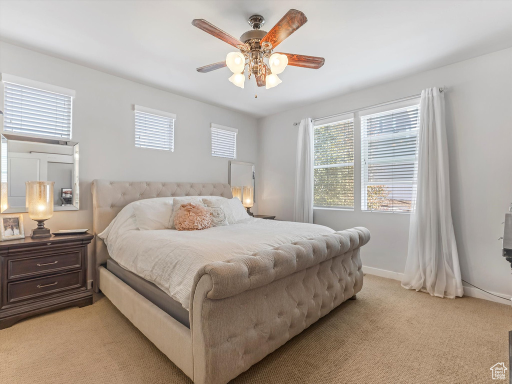Bedroom featuring light carpet and ceiling fan