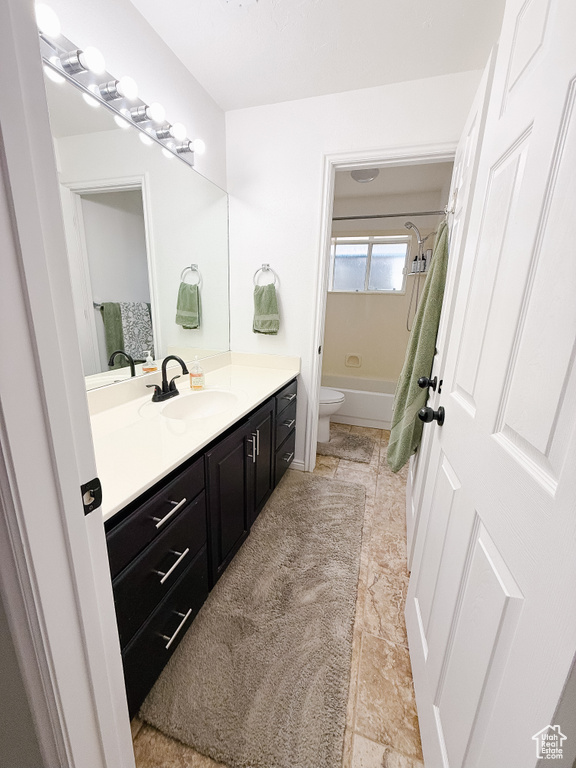 Bathroom featuring vanity and shower / bath combo
