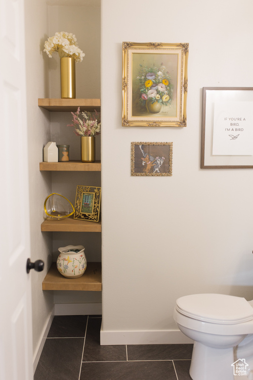 Bathroom with tile patterned floors and baseboards