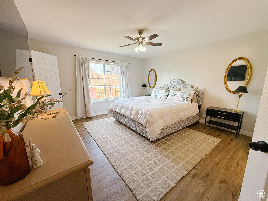 Bedroom with wood finished floors and ceiling fan