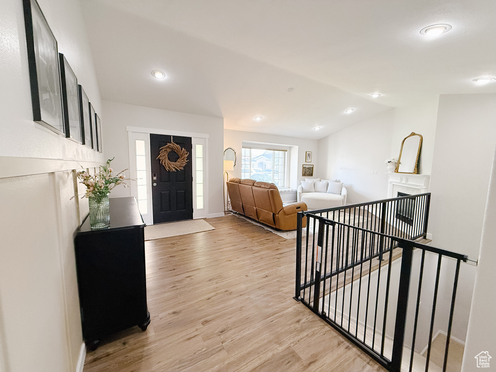 Foyer with light wood-type flooring, recessed lighting, and lofted ceiling