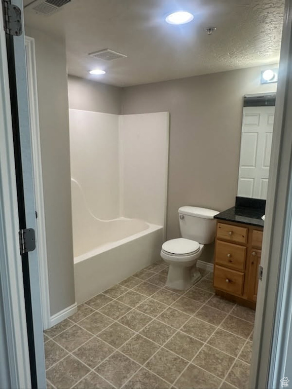 Bathroom featuring vanity, tile patterned floors, and tub / shower combination