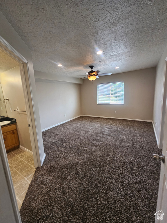 Empty room with light colored carpet, ceiling fan, a textured ceiling, and recessed lighting