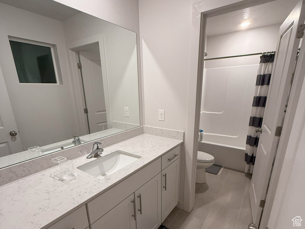 Full bath with vanity, shower / bathtub combination with curtain, and tile patterned flooring