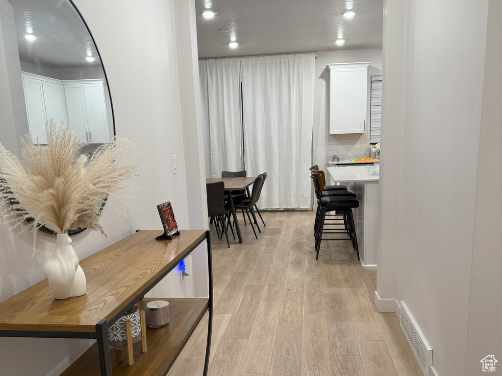 Hallway featuring light wood-style floors