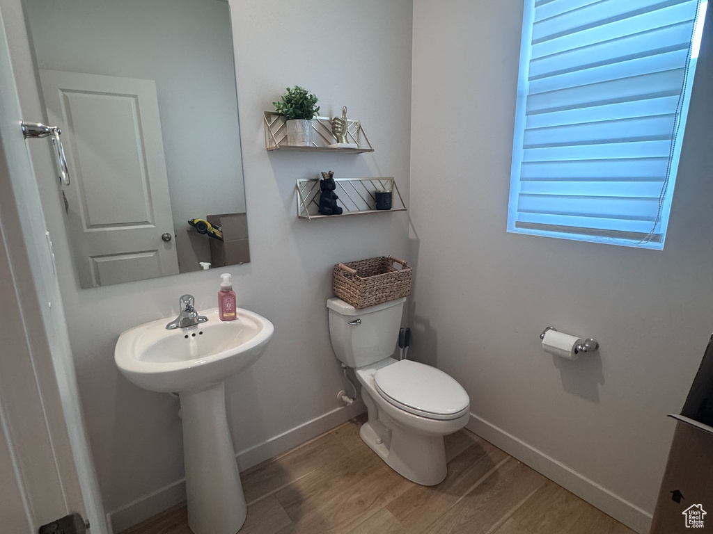 Half bath with wood finished floors
