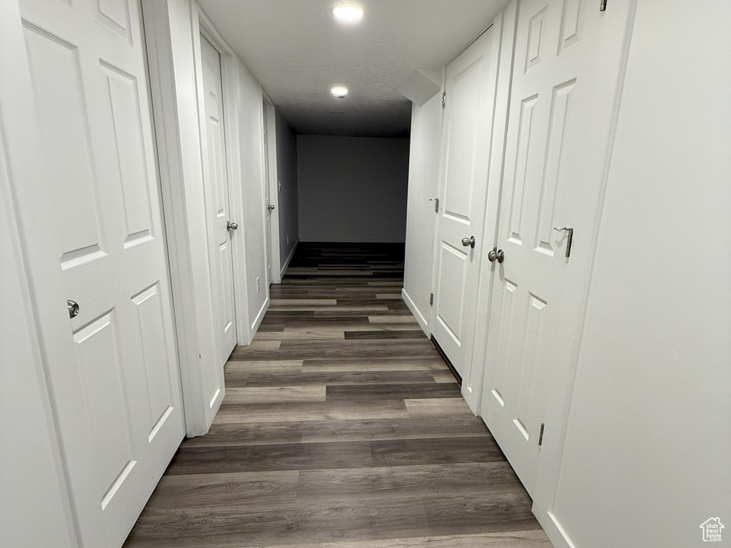 Hallway featuring dark wood finished floors and recessed lighting