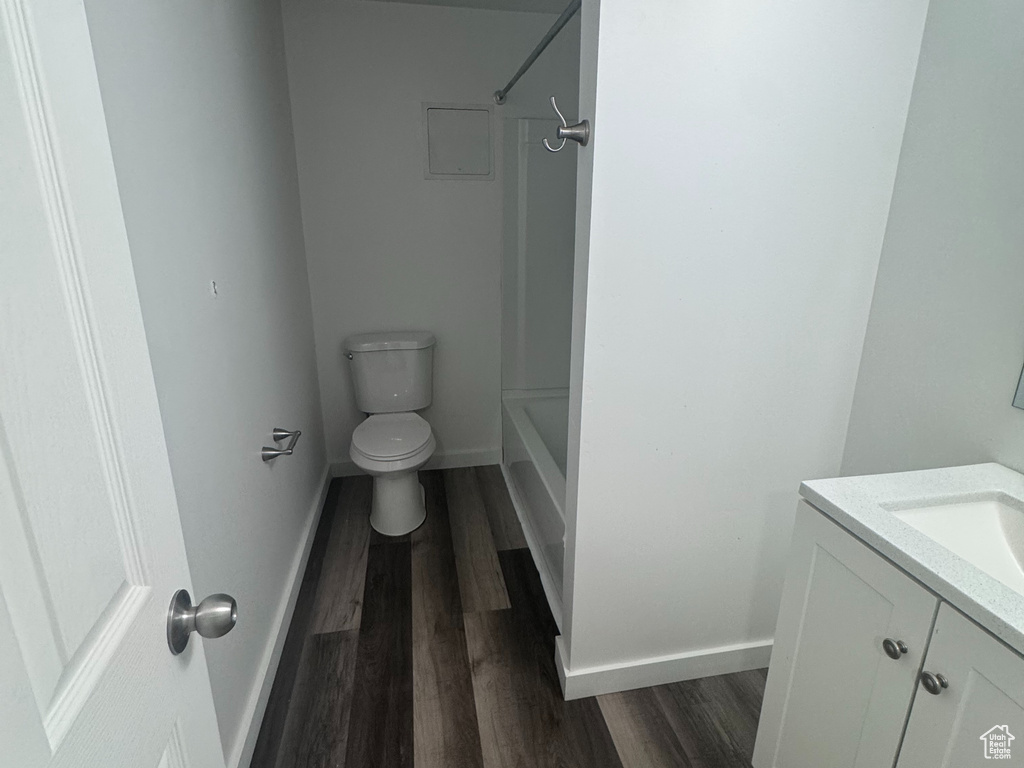 Full bath featuring vanity, wood finished floors, tub / shower combination, and a textured ceiling