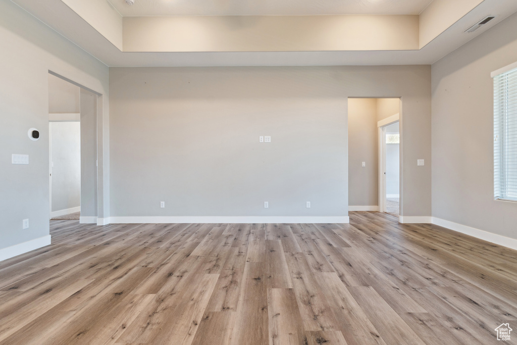 Empty room with light wood finished floors and baseboards