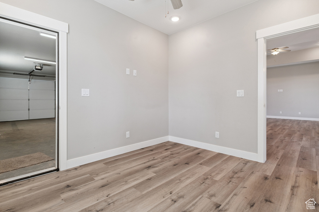 Empty room with ceiling fan, wood finished floors, and recessed lighting