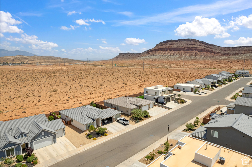 Aerial view of residential area with a mountainous background and a desert landscape