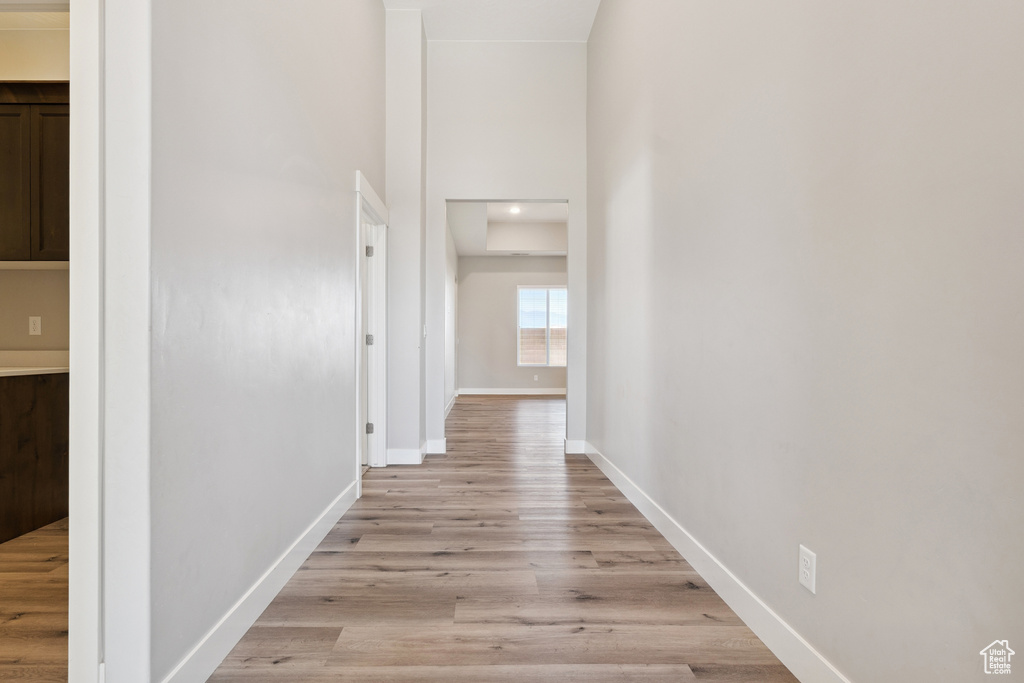 Hallway with baseboards and light wood-type flooring