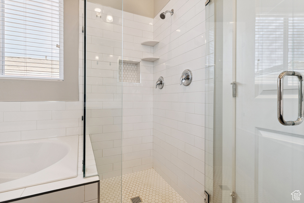 Bathroom featuring a stall shower and a bath
