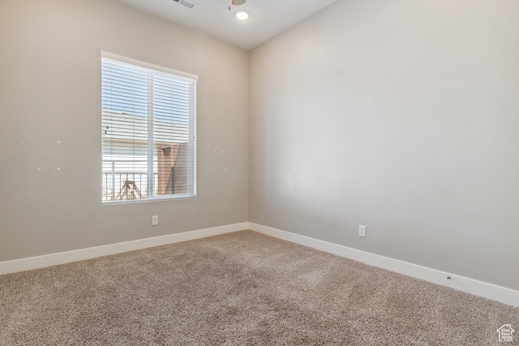 Carpeted spare room with baseboards