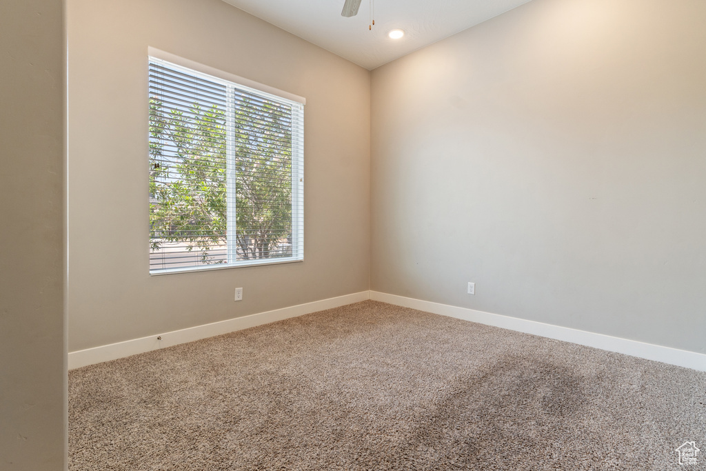Empty room featuring carpet flooring, ceiling fan, and recessed lighting