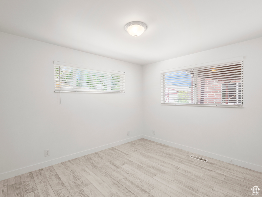 Empty room featuring healthy amount of natural light and light wood-style flooring